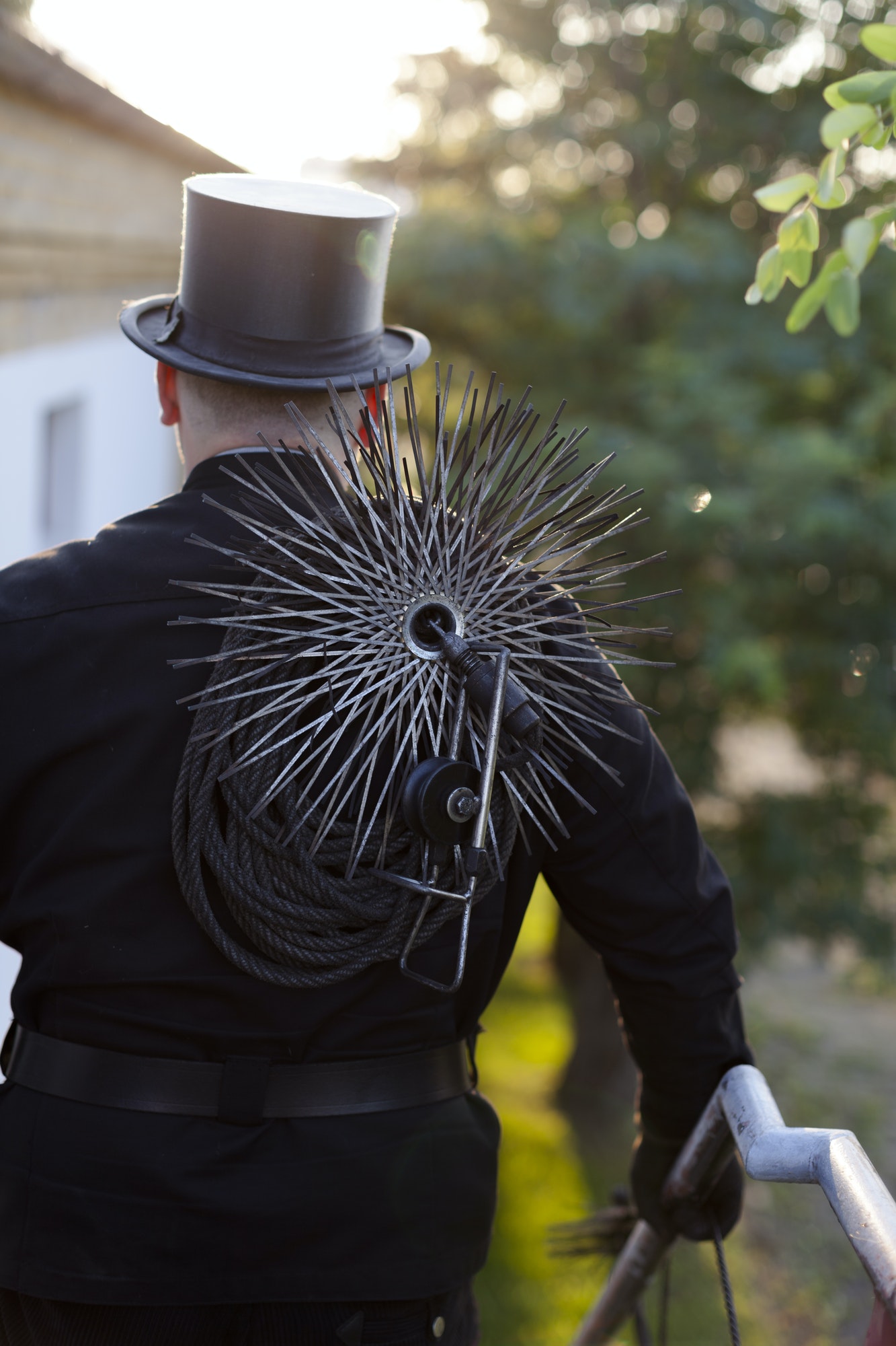 Germany, chimney sweep with working tools, back view